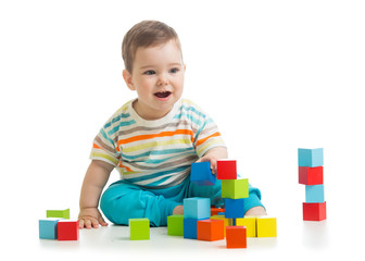 Baby building from toy blocks. Isolated on white background