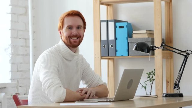 Man with Red Hairs at Work Smiling  toward Camera