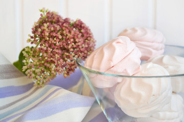 Light air dessert -zephyr (marshmallow) - in a glass vase on white wooden background