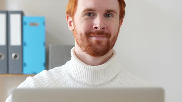 Thumbs Up by Man with Red Hairs and Beard at Work