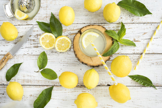 Lemon with lemonade on wooden background