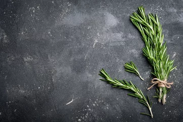 Garden poster Aromatic Rosemary on dark concrete table top view. Herbs and spices background. Copy space for your recipe