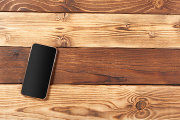 Blank screen smartphone on wooden background