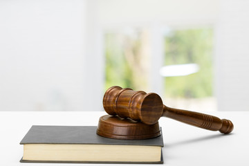 Wooden gavel and books on wooden table