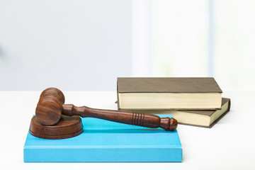 Wooden gavel and books on wooden table