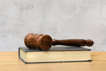 Wooden gavel and books on wooden table
