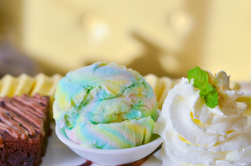 Delicious ice rainbow, brownie, cake, vanilla cream and banana in holiday.