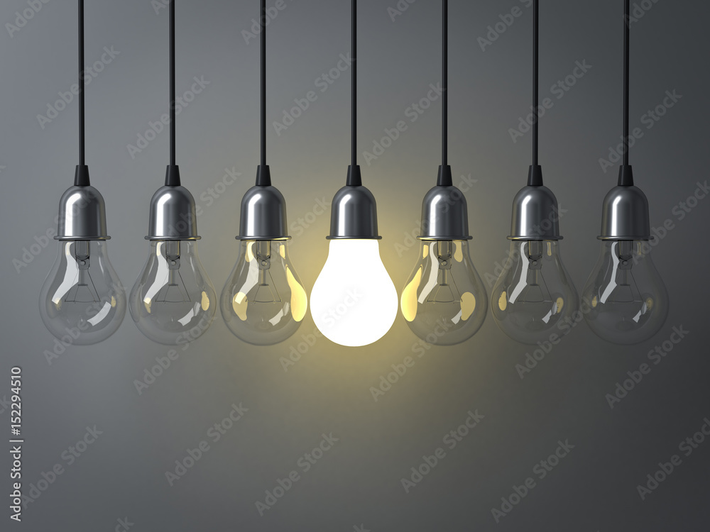 Fototapete One hanging light bulb glowing different and standing out from unlit incandescent bulbs with reflection on dark grey background , leadership and different business creative idea concept. 3D rendering.