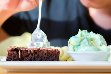 Delicious ice rainbow, brownie, cake, vanilla cream and banana in holiday.