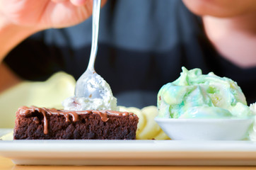Delicious ice rainbow, brownie, cake, vanilla cream and banana in holiday.