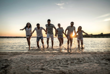 Silhouette of group young people on the beach.