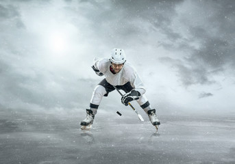 Fototapeta na wymiar Ice hockey player on the ice, outdoors