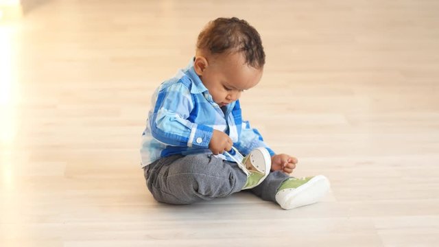 Cute african baby sitting on a floor