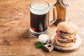 Hamburger and dark beer in vintage style