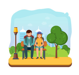 Young couple is resting on park bench after a walk.