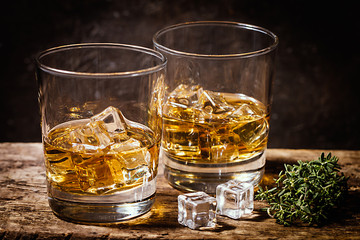 Whiskey with ice in glasses