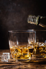 Whiskey with ice in glasses