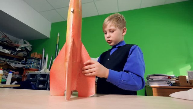 Boy looking at the rocket model. 4K.