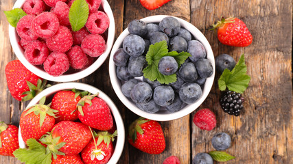 strawberry,blueberry and raspberry on wood background