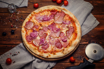 Pizza, Pizza knife and ingredients  on a wooden background. view from above