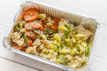 Healthy food in foil boxes, diet concept.