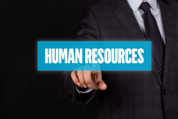 Hand pushing on a touch screen interface HUMAN RESOURCES button