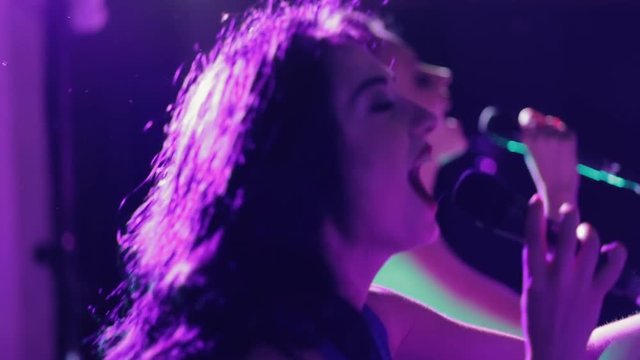 Beautiful charismatic two women singer performing at music event