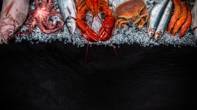 Fresh tasty seafood served on old wooden table.