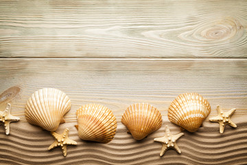Summer background - Wooden table, shells and sand