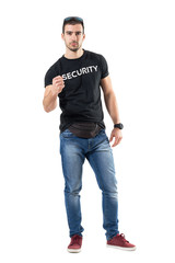 Young confident police officer in plain civilian clothes with clenched fist. Full body length...