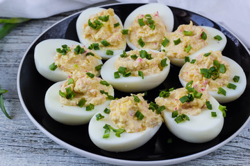 Home eggs stuffed with cheese and crab topped with green onions