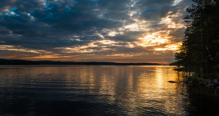 Scenic landscape with lake and sunset at summer evening in Finland