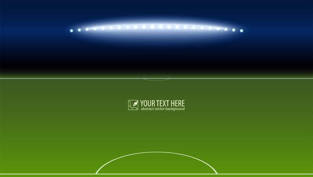 Green soccer field from the goalkeeper area with the spotlights with copy-space for your text or message. Lighted football field, horizontal image with aspect HD video.