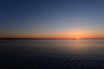 Strip of bright pink evening against the blue sky