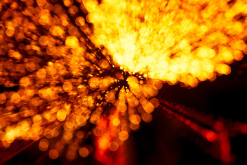 Abstract style colorful photo of fireworks in a red tone. Artistic, blurry, colorful look.
