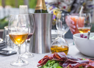 Glass of wine and prosciutto shown close-up