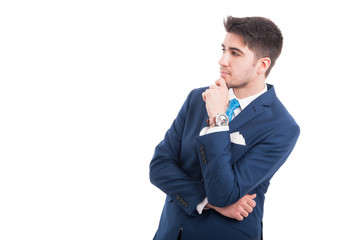 Young pensive lawyer or broker in formal suit