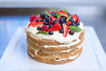 Delicious raspberry cake with fresh strawberries, raspberries, blueberry, currants 