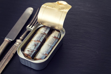 canned fish on wooden background