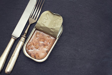 canned fish on wooden background