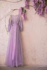Fototapeta na wymiar Vintage lace dress with flowers on the wall