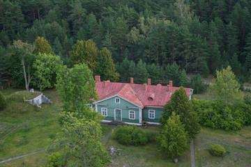 Fototapeta na wymiar View from above, houses located among the trees. Kolka, Latvia