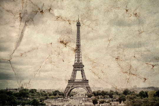 Eiffel Tower in Paris. Vintage view background. Tour Eiffel old retro style photo with cracks crumpled paper. Postcard style. 