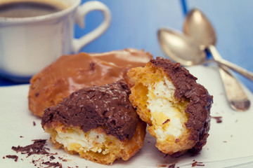 eclairs on white dish on wooden background