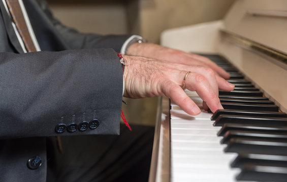 Old Man Hands Playing On Piano (shallow DOF)