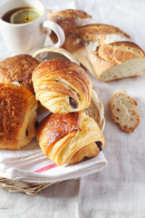 French pastry:  puff chocolate buns, baguette and cup of tea