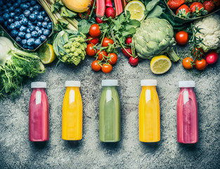 Variety of colorful Smoothies or juices bottles beverages drinks with various fresh ingredients:...