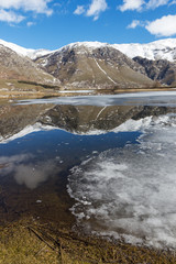 view of frozen mountain lake