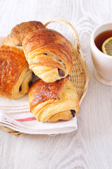 French puff pastry: sweet chocolate buns and cup of tea