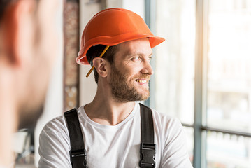 Happy smiling constructor wearing helmet
